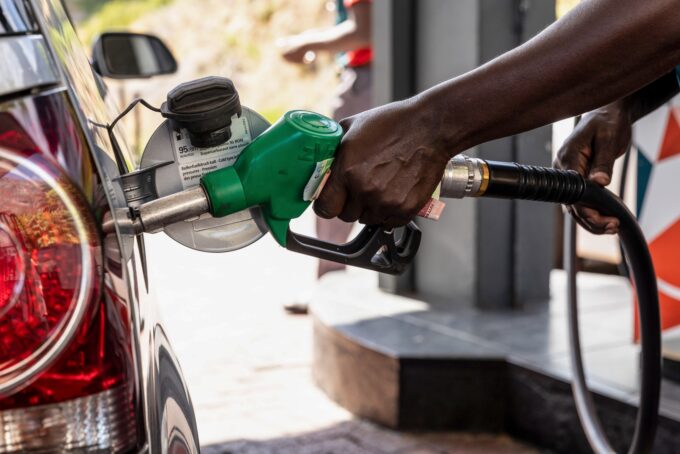 Fuel attendant refueling a car at the station.