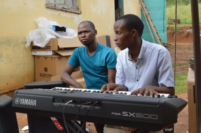 Deputy Prime Minister Thulisile Dladla hands over musical instruments to Nkosenomusa Sibaya Gamedze, a visually impaired musician, in a gesture of support for his musical career.