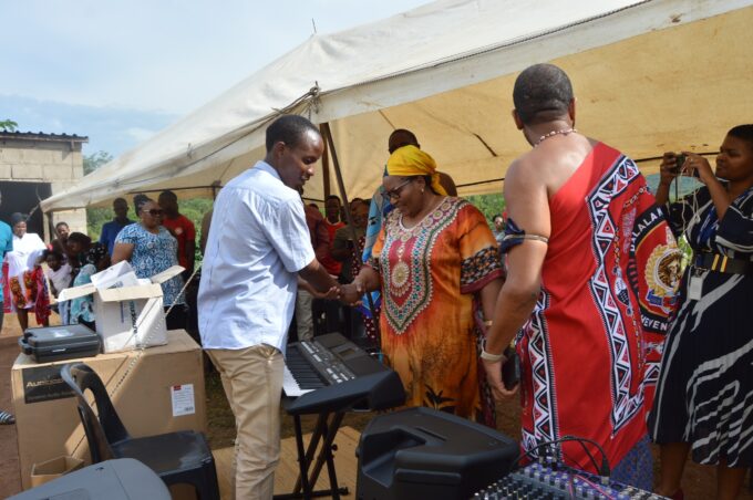Deputy Prime Minister Thulisile Dladla hands over musical instruments to Nkosenomusa Sibaya Gamedze, a visually impaired musician, in a gesture of support for his musical career.