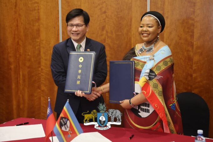Eswatini and Taiwan officials shake hands after signing a pact to combat disinformation.