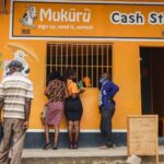 Customers queue at a Mukuru cash collection point