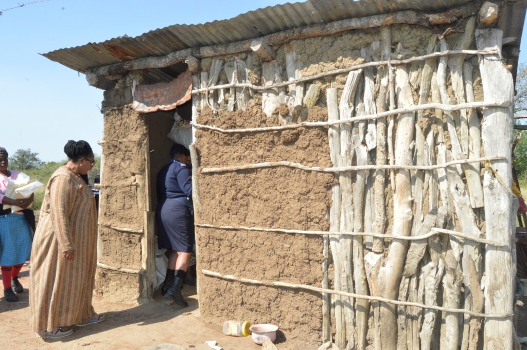 Deputy Prime Minister Thulisile Dladla inspects a dilapidated homestead in Mpolonjeni Inkhundla during a visit to assess housing needs among vulnerable families.