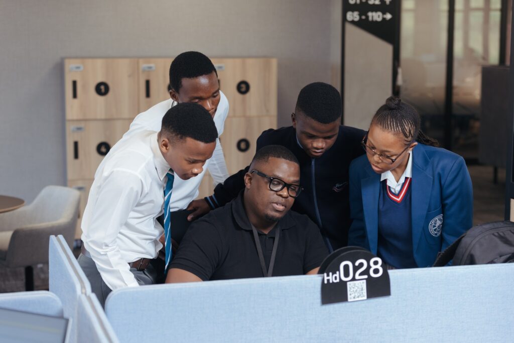 FNB Eswatini staff engage with students during a hands-on session as part of the bank’s job shadowing initiative in partnership with JA Eswatini.