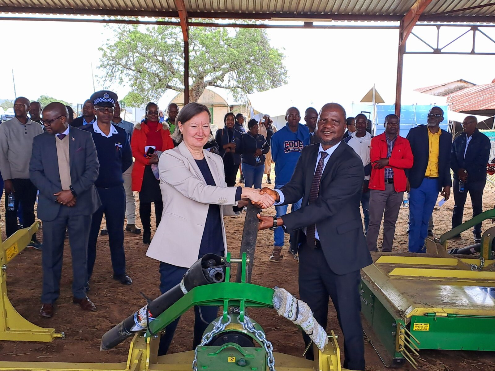 Minister of Agriculture Jabulani Mabuza and the European Union representative share a moment during the official handover of hay-making equipment worth E3.1 million at Mpisi Cattle Breeding Station.
