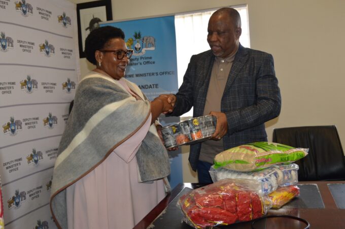 Deputy Prime Minister Thulisile Dladla receives food parcels from Reverend Johannes Mazibuko of Mbabane Alliance Church during the official handover ceremony at the DPM’s Office. The donation will support vulnerable communities across Eswatini. Photo by DPM Office