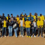 MTN Eswatini CEO Wandile Mtshali joins frontline staff for a group photo during the final stop of the nationwide roadshow in Nhlangano.