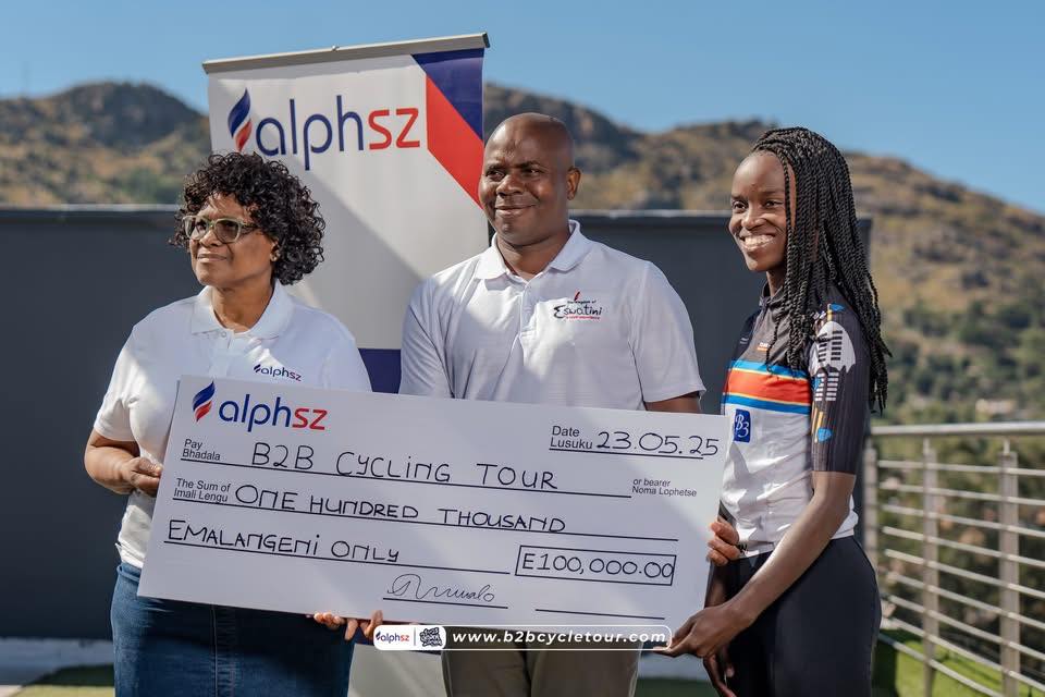 AlphSZ CEO Thandile Nxumalo presents a symbolic cheque of E100 000 in support of the Border to Border Cycle Tour, joined by event partners and tourism officials in Mbabane.
