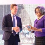 UNDP Resident Representative, Mr. Henrik Franklin, hands over the 2025 Human Development Report to the Minister of ICT, Hon. Savannah Maziya. UNDP/Thoba Dlamini