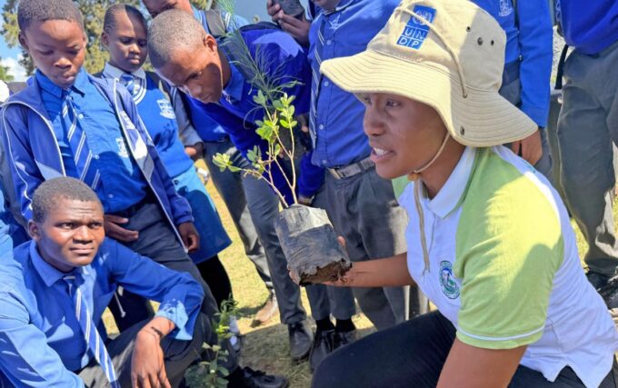 Zandisile Howe from the Eswatini Environment Authority guides students at Shewula High School during the Hlanyela Likusasa tree planting campaign.