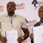 Mr Mandla Nkambule, CEO of YERF, and Mr Nsikelelo Dlamini, Acting Town Clerk of Siteki Town Council, display the signed Memorandum of Understanding at the Lubombo Youth Business Seminar.