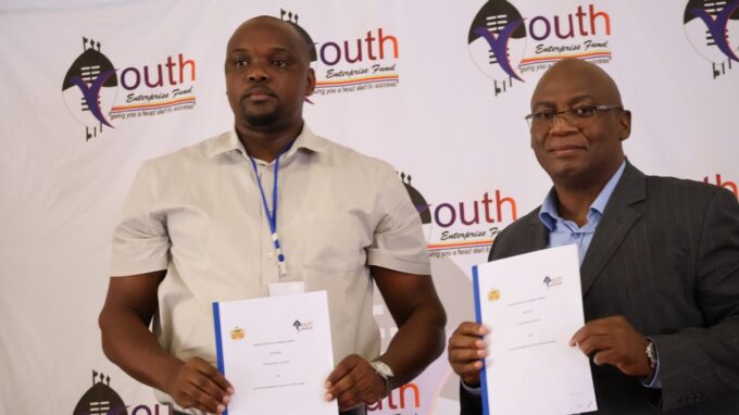 Mr Mandla Nkambule, CEO of YERF, and Mr Nsikelelo Dlamini, Acting Town Clerk of Siteki Town Council, display the signed Memorandum of Understanding at the Lubombo Youth Business Seminar.