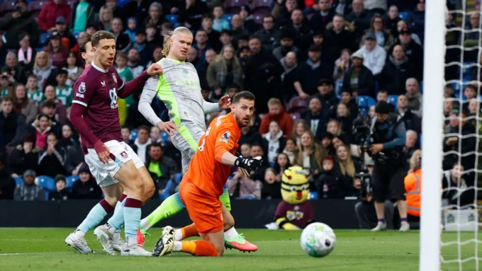 Erling Haaland celebrates after scoring the only goal of the game for Manchester City against relegated Burnley at Turf Moor, a result that sent City to the top of the Premier League table.