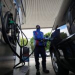 A worker fills a car at a petrol station in Cape Town, South Africa, March 25, 2026. REUTERS/Esa Alexander