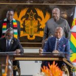 Presidents John Dramani Mahama of Ghana and Emmerson D. Mnangagwa of Zimbabwe stand behind their respective Foreign Affairs Ministers during the signing ceremony in Accra.