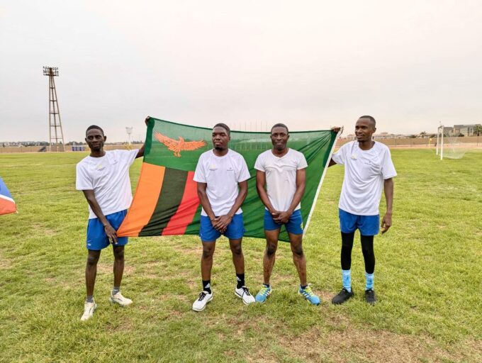 Zambia Revenue Authority players celebrate with their national flag after winning the SAIRAG 2026 football title in Swakopmund. Photo by Zambia Revenue Authority
