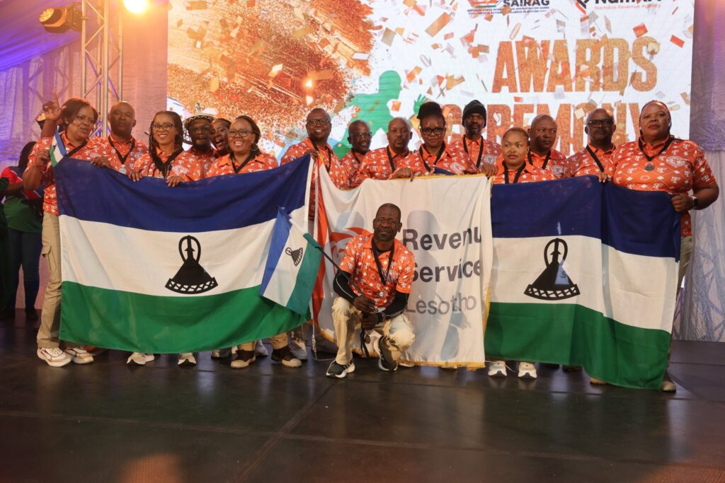 Team Lesotho celebrates their impressive medal haul at SAIRAG 2026, holding gold, silver, and bronze trophies won in individual and team events. Photo by RSL