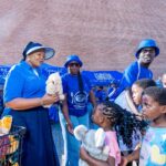 Minister for Foreign Affairs and International Cooperation Pholile Shakantu presents toys and gifts to children who attended the Embiveni Meats Candana Ja activation, bringing smiles to over 40 young guests. Photo by Tribe Studios.