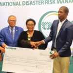 eputy Prime Minister Thulisile Dladla presents a cheque of E5,000 to Mlungisi Zibonele Bhembe at the launch of Umvalo Wesive, after he won the siSwati naming competition for coining the name of the Kingdom's new National Disaster Risk Management Authority.