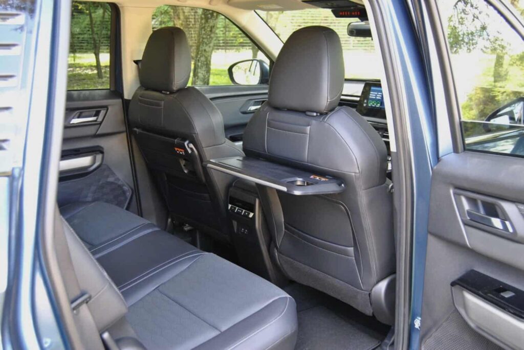 A pair of folding trays for the second row have been integrated into the seatbacks of the front chairs. Picture: Charl Bosch