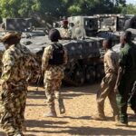 Nigerian soldiers walk past military tanks in Maiduguri, Borno State, Nigeria on November 7, 2025 [File: Ahmed Kingimi/Reuters]