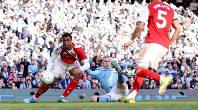 Erling Haaland tucks the ball into the bottom corner to restore Manchester City's lead against Arsenal at the Etihad Stadium, securing a 2-1 victory that has thrown the Premier League title race wide open, April 19, 2026.