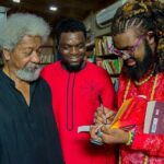 Nigerian author and filmmaker Onyeka Nwelue signs a copy of his book "The Beginning of Everything Colorful" for Nobel Laureate Wole Soyinka,