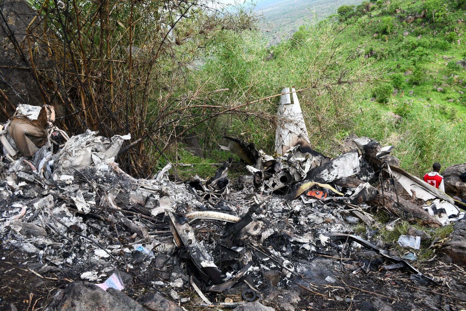 A member of the South Sudan Red Cross walks at the wreckage of a Cessna 208 Caravan operated by CityLink Aviation, that lost communication and crashed while flying from Yei to Juba International Airport, in Juba, South Sudan April 27, 2026. REUTERS/Samir Bol