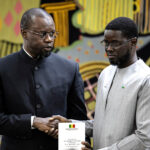 Discord has grown between Senegal's now-dismissed Prime Minister Ousmane Sonko (L) and President Bassirou Diomaye Faye (R) pictured during an 2025 event in Dakar. © Patrick Meinhardt, AFP