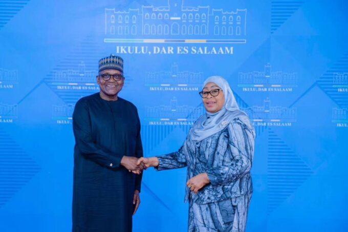 Tanzanian President Samia Suluhu Hassan and Dangote Industries Limited President and CEO Aliko Dangote shake hands during high-level discussions on industrialisation, regional energy infrastructure, and long-term economic development across Africa.