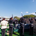 Soldiers fire a salute as the coffin of former Botswana President Festus Gontebanye Mogae is lowered to rest at Phomolong Cemetery in Gaborone during a state burial conducted with full military honours.