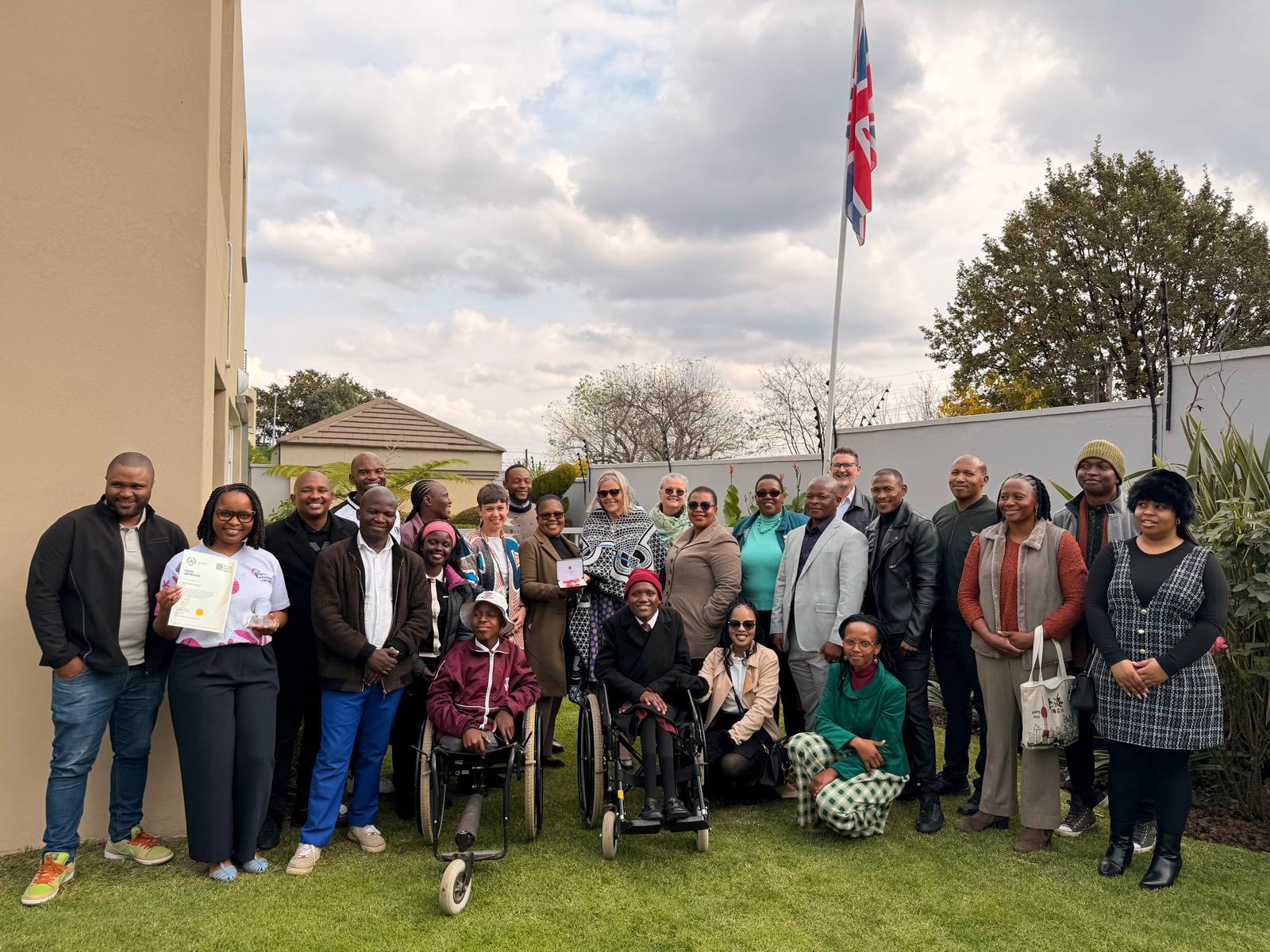 Jan Jeffrey, MBE recipient, and Ms Tleetse Phakoe, Queen Elizabeth Commonwealth Trust Young Leader Awardee, pictured with British High Commission representatives in Lesotho during a ceremony honouring their outstanding contributions to community health and women's empowerment. Photo by UK in Lesotho