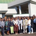 ENTC Chief Executive Officer Thulani Methula, Acting Principal Secretary for the Ministry of Tourism and Environmental Affairs Dudu Nhlengethwa-Masina, and youth participants pose for a group photo at the Youth Engagement Workshop held at King Sobhuza Memorial Park