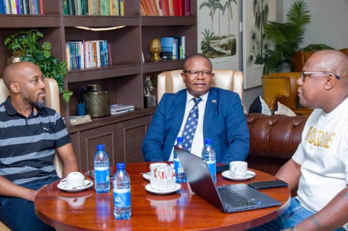 Leap Taxi App director Vusani Matsebula presents the Zanzibar trip itinerary to the Minister of Commerce, Industry and Trade during a courtesy visit by A Peculiar People chairman Melusi Zox Dlamini