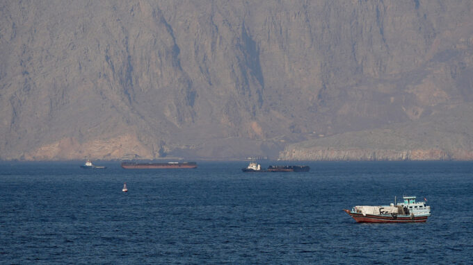 US military vessels escort commercial ships through the Strait of Hormuz on Monday