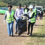 Community members, Siteki Town Council officials and representatives from participating organisations collect litter along the entrance points of Siteki Town during a World Environment Day clean-up campaign. (Photo: Siteki Town Council)