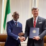 Nigeria’s Minister of Solid Minerals Development Dele Alake and US Deputy Secretary of State Christopher Landau shake hands after signing the mining cooperation agreement in New York, with copies of the MoU in hand. Photo: X/@AlakeDele