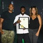 Maryland Gov. Wes Moore (left) and First Lady Dawn Moore (right) present a citation to Michael Awosanya, Afro Fest founder and executive producer. Photo Credit: Photo courtesy of Flickr