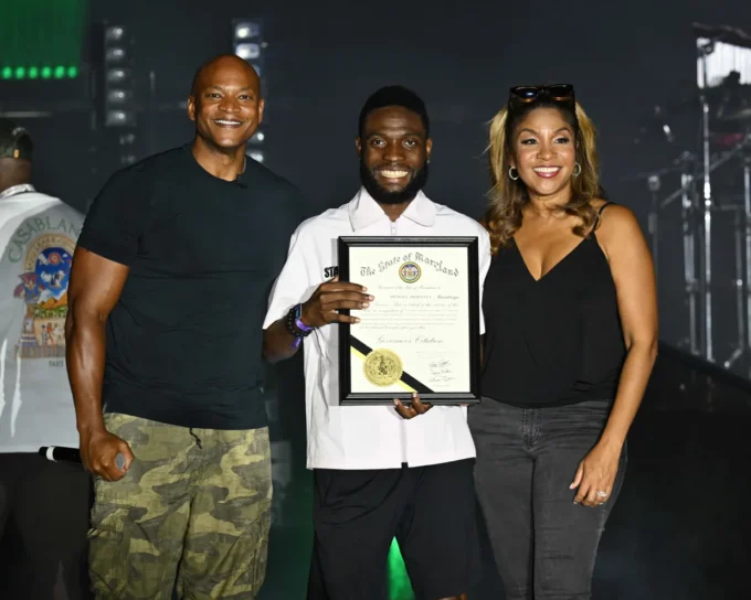 Maryland Gov. Wes Moore (left) and First Lady Dawn Moore (right) present a citation to Michael Awosanya, Afro Fest founder and executive producer. Photo Credit: Photo courtesy of Flickr