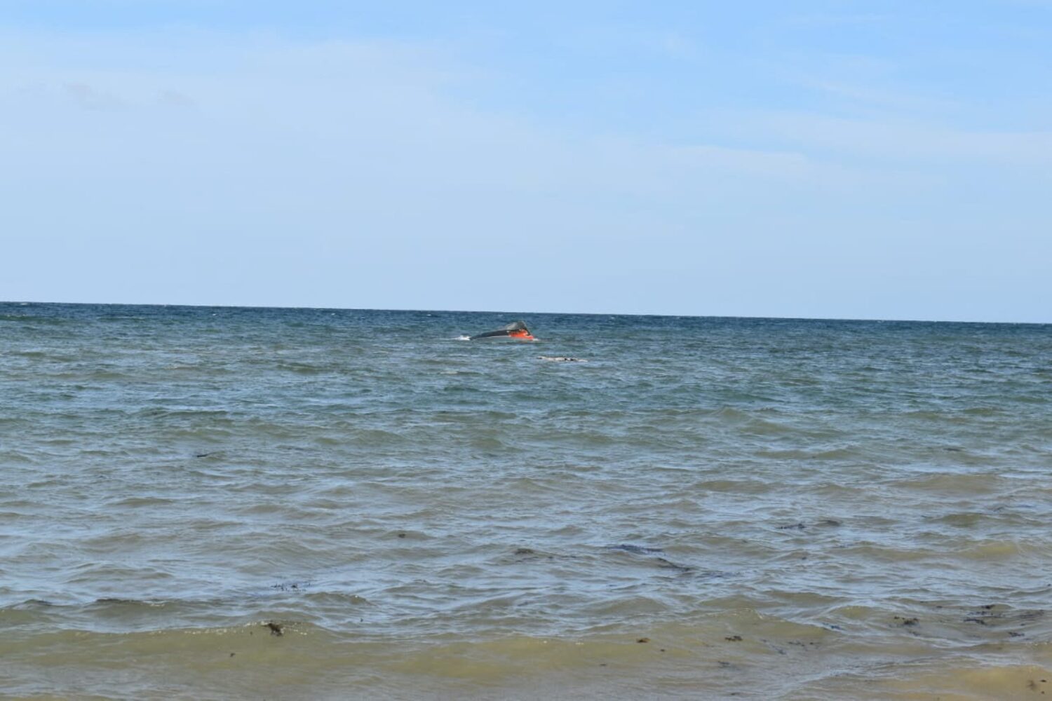 A portion of the vessel floats after it capsized while carrying about 305 people from Djibouti to Yemen, leaving at least 109 migrants, including 15 children, dead and more than 116 missing, according to the United Nations' International Organization for Migration (IOM) on October 10, near Guhere, north of the port town of Obock, Djibouti, in this photograph released on October 10, 2026.